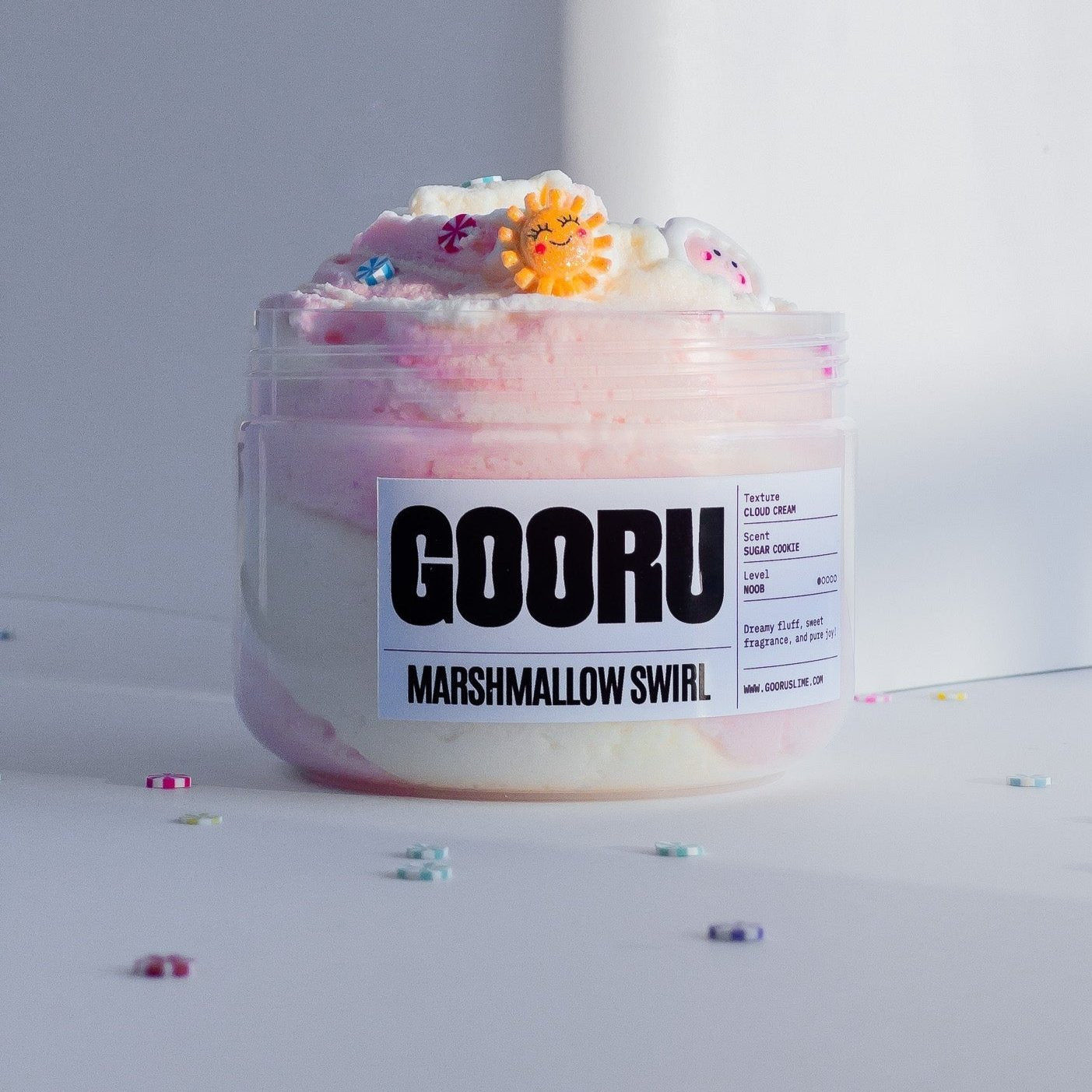 A Jar of Marshmallow Slime with a smiley sun charm. Designed by Gooru Slime UAE